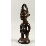 A SMALL TRIBAL FETISH FIGURE, wearing a bead necklace. 22cms high.