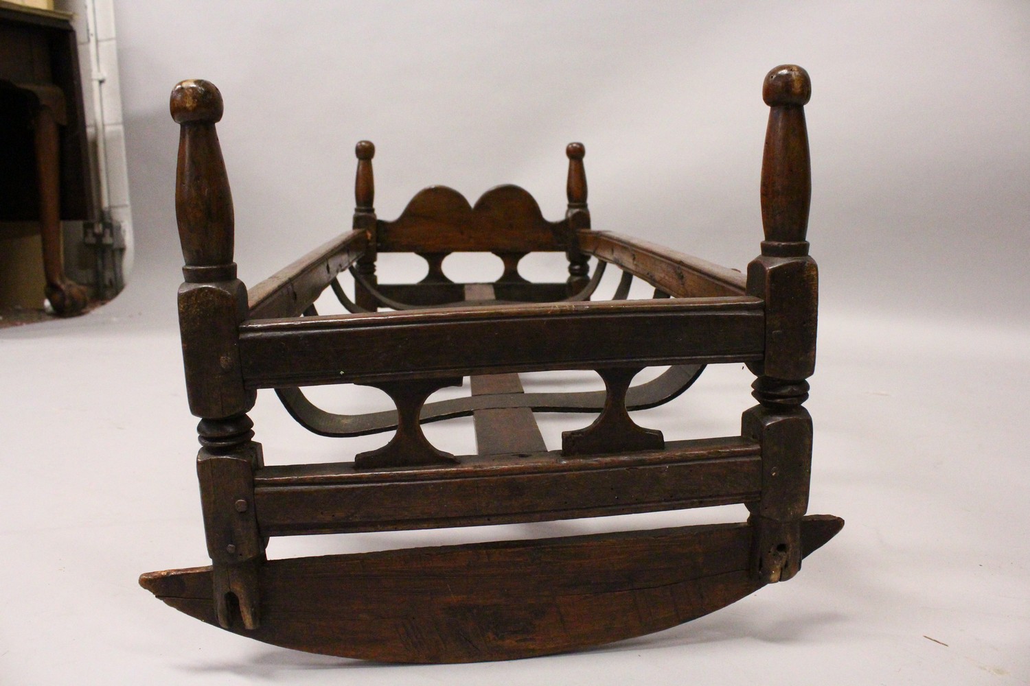 A 19TH CENTURY BEECH CRADLE, with pierced ends, turned corner columns and a slatted base on rockers. - Image 4 of 7