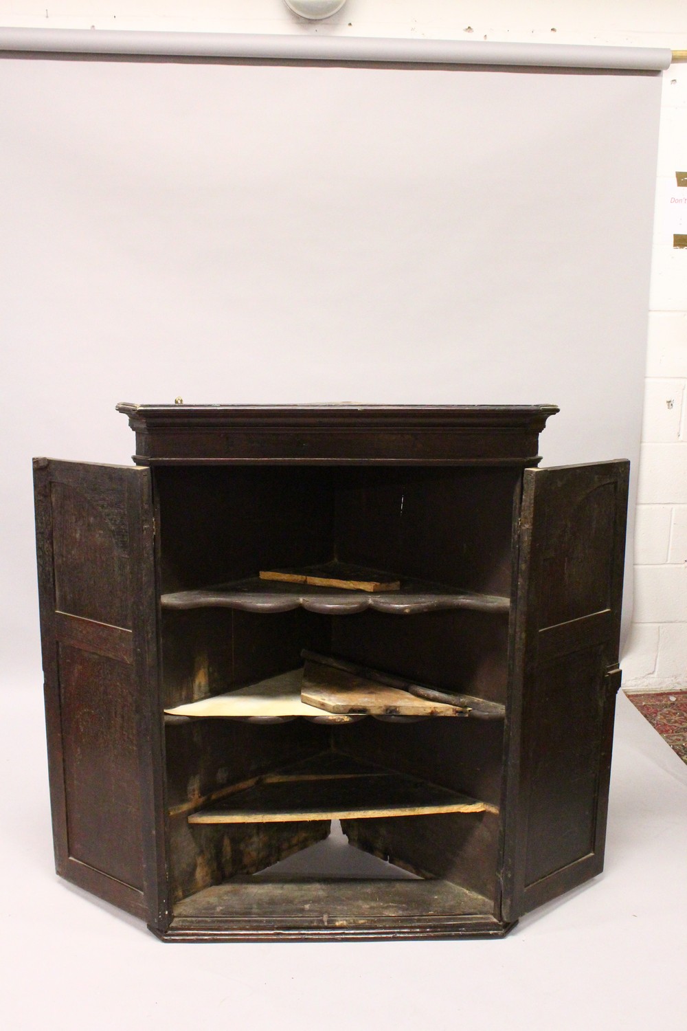 A 19TH CENTURY OAK HANGING CORNER CUPBOARD, with a pair of panelled doors enclosing three shelves. - Image 4 of 8