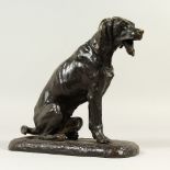 A BRONZE MODEL OF A SEATED HOUND, late 19th century, with an articulated jaw. 26cm high.