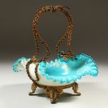 A VICTORIAN PALE BLUE GLASS BASKET, painted with flowers, with gilt metal handle and stand. 23cm
