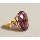 A 14CT GOLD AND AMETHYST RING.