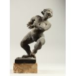 A GROTESQUE SCULPTURE OF A WOMAN, on a square base. 36cms high.