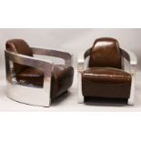 AN UNUSUAL PAIR OF ART DECO STYLE ALUMINIUM AND LEATHER UPHOLSTERED ARMCHAIRS.
