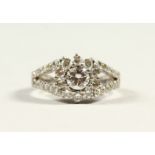 AN 18CT WHITE GOLD DIAMOND RING, the central diamond in a halo style, approx. 1ct.