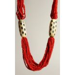 A RED BEAD NECKLACE.