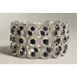 A SILVER AND REAL SAPPHIRE TRIPLE ROW WIDE BRACELET.