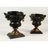A PAIR OF 19TH CENTURY CAST BRONZE URNS, with lions mask and gilded handles, the body decorated with