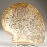 A CARVED SHELL ,depicting elephants beneath a tree. 23cm wide.