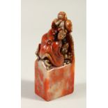 A SOAPSTONE SEAL, carved with frogs. 11cms high.