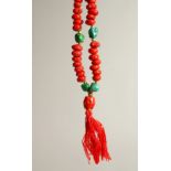 A RED AND GREEN STONE NECKLACE.