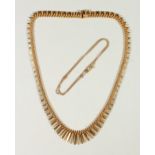 A 9CT GOLD FLEXIBLE NECKLACE.