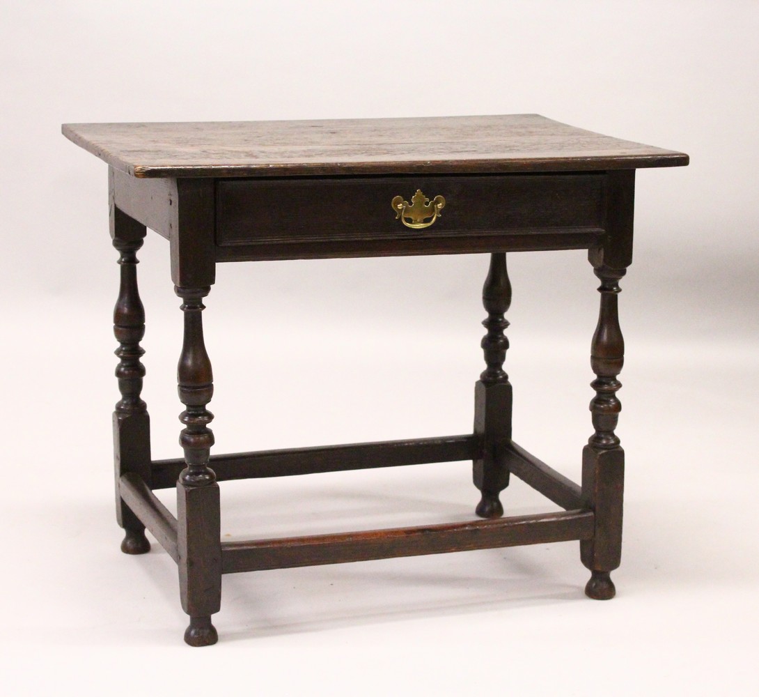 AN 18TH CENTURY OAK SIDE TABLE, with a single long drawer, on turned legs united by stretchers. 84cm