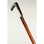 A HORN HANDLED WALKING STICK, concealing a dagger. 83cm long.