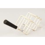 A CHRISTOPHER DRESSER DESIGN FOUR DIVISION TOAST RACK with wooden handle.