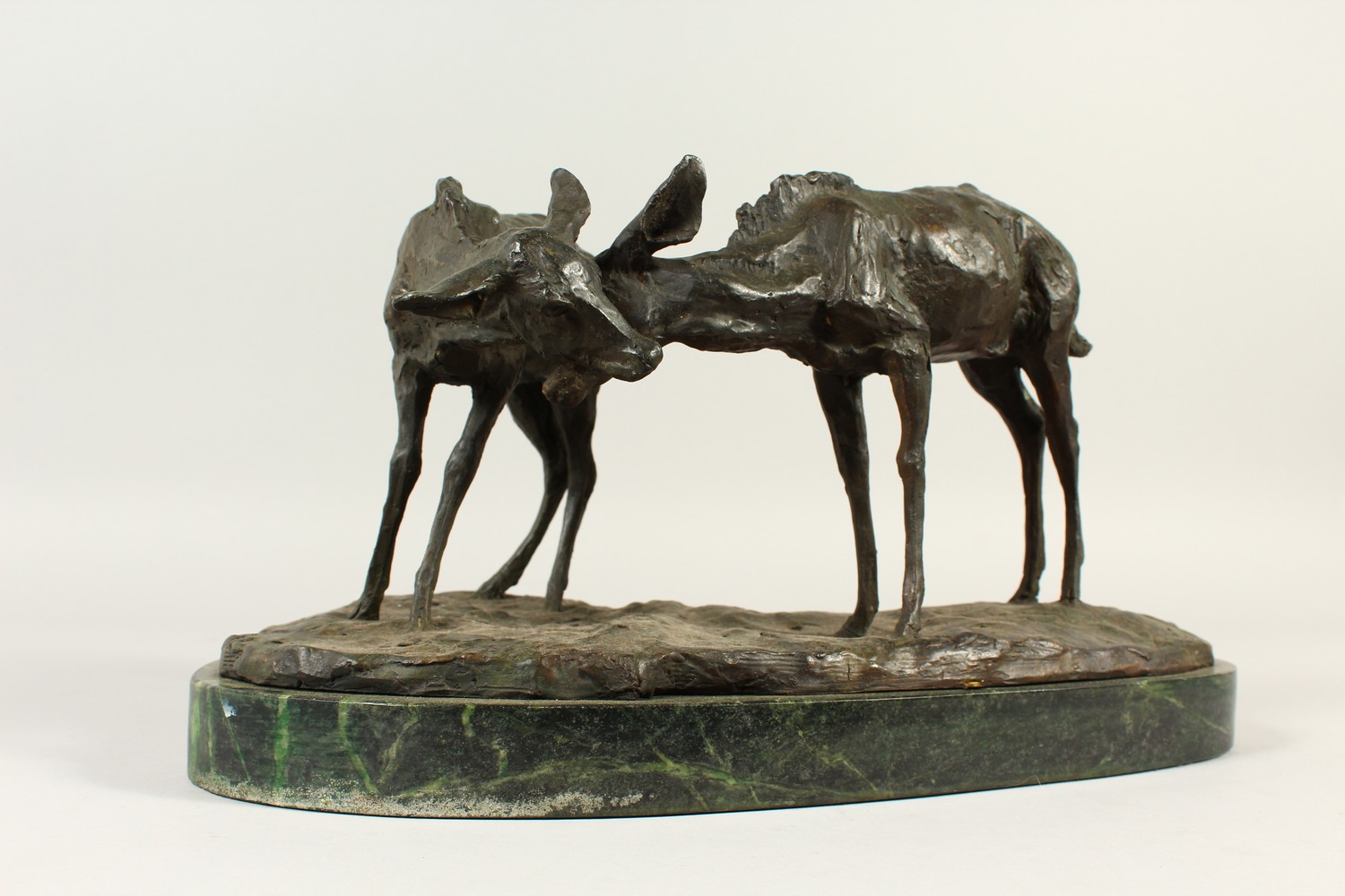 A NATURALISTIC CAST BRONZE GROUP OF TWO DEER, on a shaped marble base. 42cms wide. - Image 2 of 4