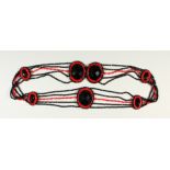 A BLACK AND RED BEAD BELT