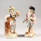 A PAIR OF CONTINENTAL PORCELAIN FIGURES of a young boy and girl carrying fruit. 5ins high.
