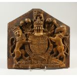 A VERY WELL CARVED WOODEN ROYAL COAT OF ARMS. 34cms long, 35cms wide.