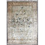 A GOOD SILK "TREE OF LIFE" RUG, pale green ground decorated with animals, birds and fruit. 210cm x