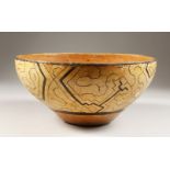 A PERUVIAN SHIPIBO CULTURE CIRCULAR BOWL, the inside decorated with a FACE. 13cms high x 25cms