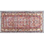 A PERSIAN RUG, pale purple ground with colourful stylised decoration. 190cm x 100cm.