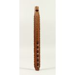 AN EASTER CARVED WOOD FLUTE. 32cms long.