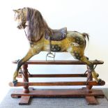 A VERY GOOD VICTORIAN CARVED WOOD AND PAINTED ROCKING HORSE.