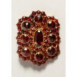 A GARNET SET BROOCH with hair pieces.