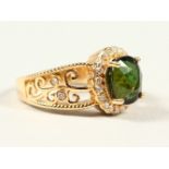 A 14K YELLOW GOLD AND DIAMOND RING, set with an oval cut green tourmaline approx. 2.95ct, diamonds