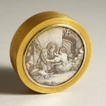 A CIRCULAR GILT METAL BOX, the top inlaid with an engraved silver plated panel. 10cms diameter.