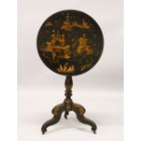 A 19TH CENTURY EBONISED CIRCULAR TILT TOP TRIPOD TABLE, with chinoiserie decoration. 74cm high x