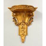 A GILDED WALL BRACKET. 20cms long.