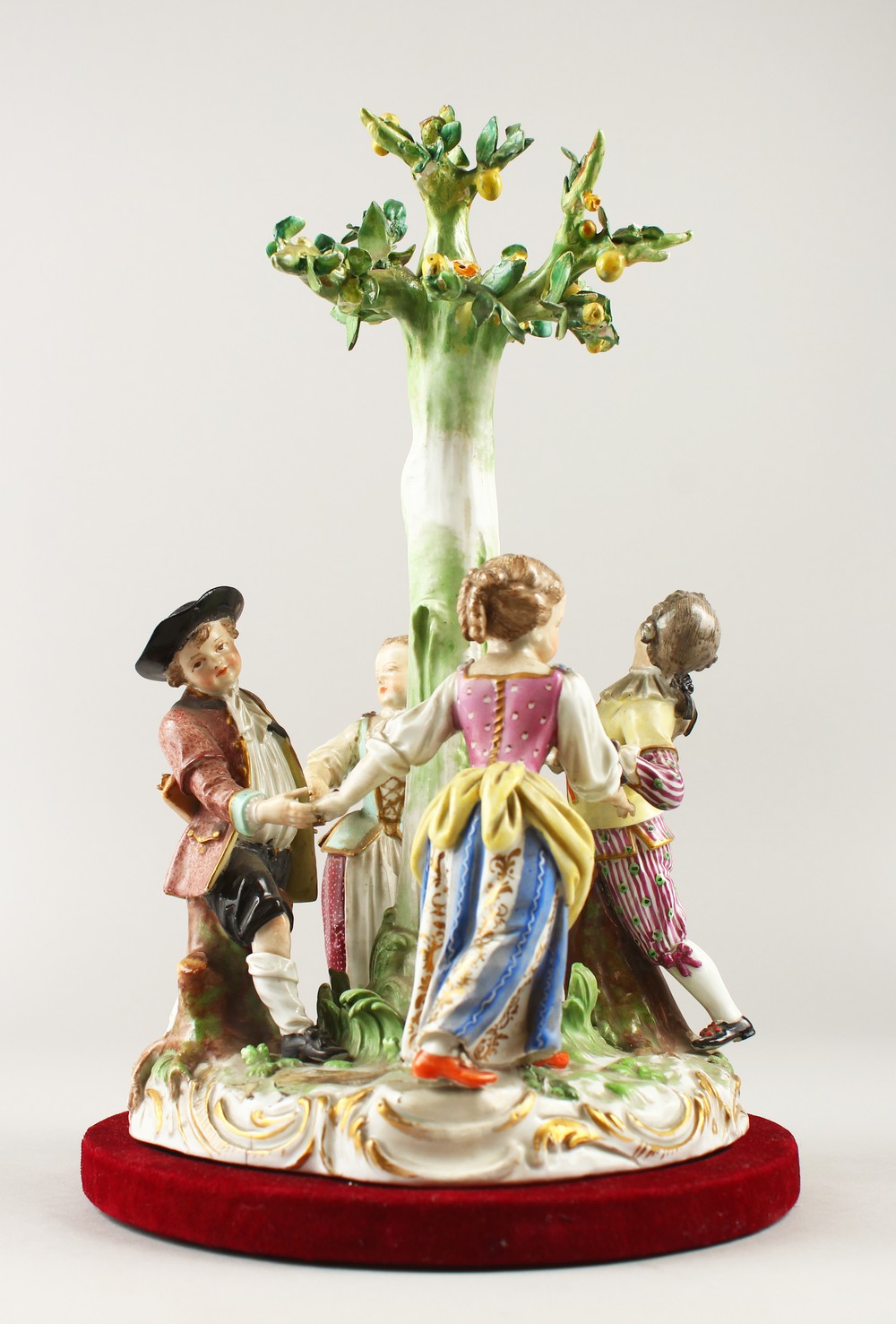 A 19TH CENTURY MEISSEN PATTERN GROUP, "RING-A-RING O' ROSES", four young figures dancing around a