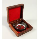 A COMPASS in a rectangular box. 11cms.