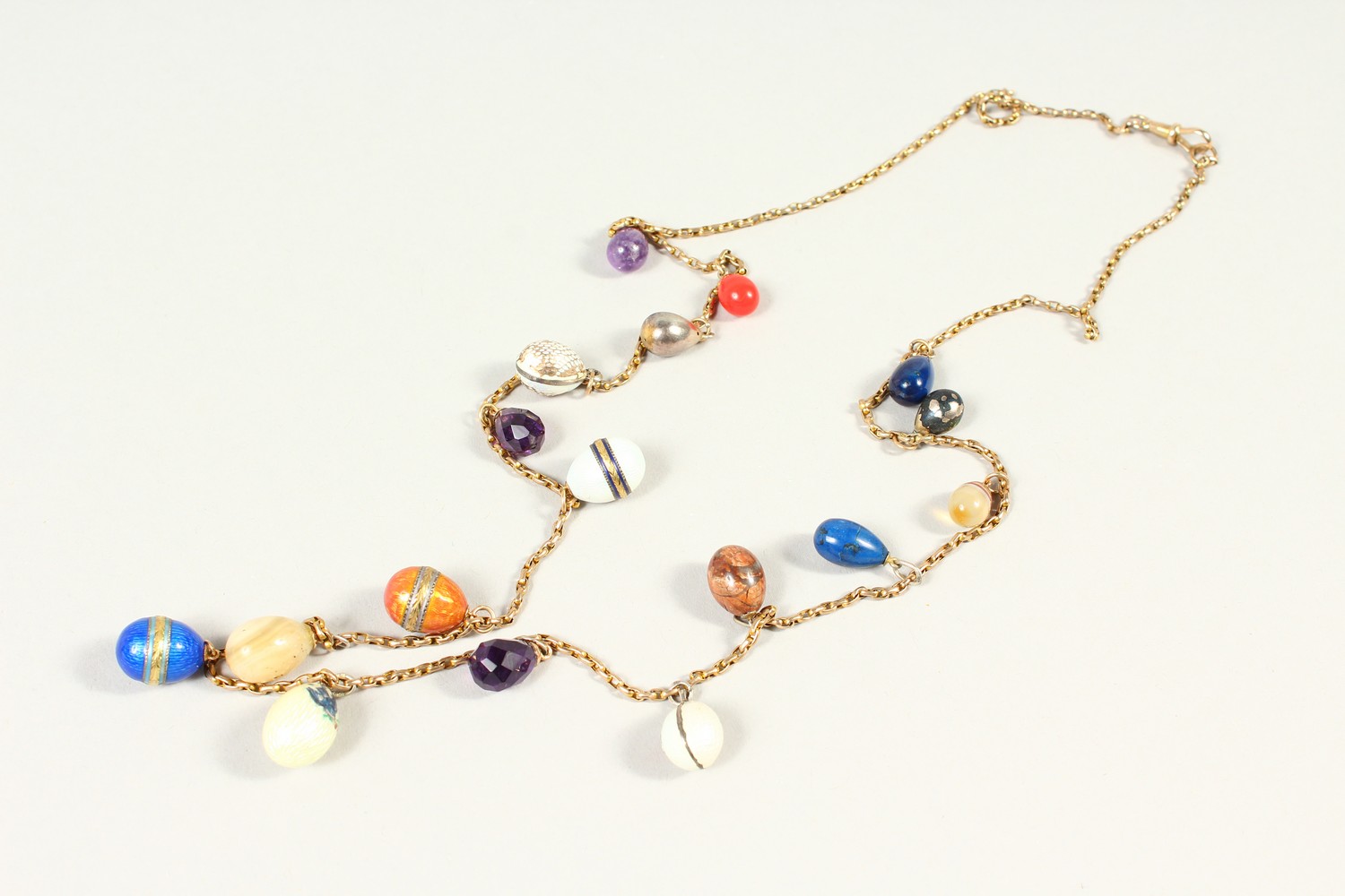 A CHAIN set with HARDSTONE EGGS. - Image 2 of 3