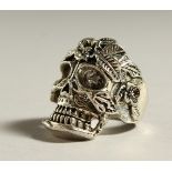 A SILVER SKULL RING.