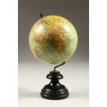 A SMALL GLOBE, on a turned wood stand. 20cms high.