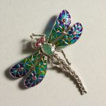 A SILVER EMERALD SET PLIQUE DRAGONFLY BROOCH.