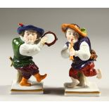 A SMALL PAIR OF CAPODIMONTE FIGURES OF DWARFS, playing musical instruments. 11cms high.