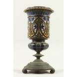 A DOULTON LAMBETH STONEWARE VASE, on a cast iron stand. 33cm high.