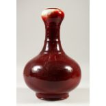 A SANG DE BOEUF GARLIC NECK VASE, of bulbous form. 33cms high.