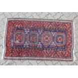 A SMALL PERSIAN RUG, blue ground with four medallions. 146cm x 89cm.