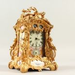 A ROCOCO STYLE CARRIAGE CLOCK, with Sevres style pink porcelain panels, decorated with nesting