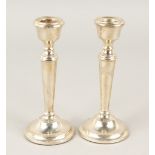 A PAIR OF CIRCULAR TAPERING CANDLESTICKS. 16cms high. London 1969.