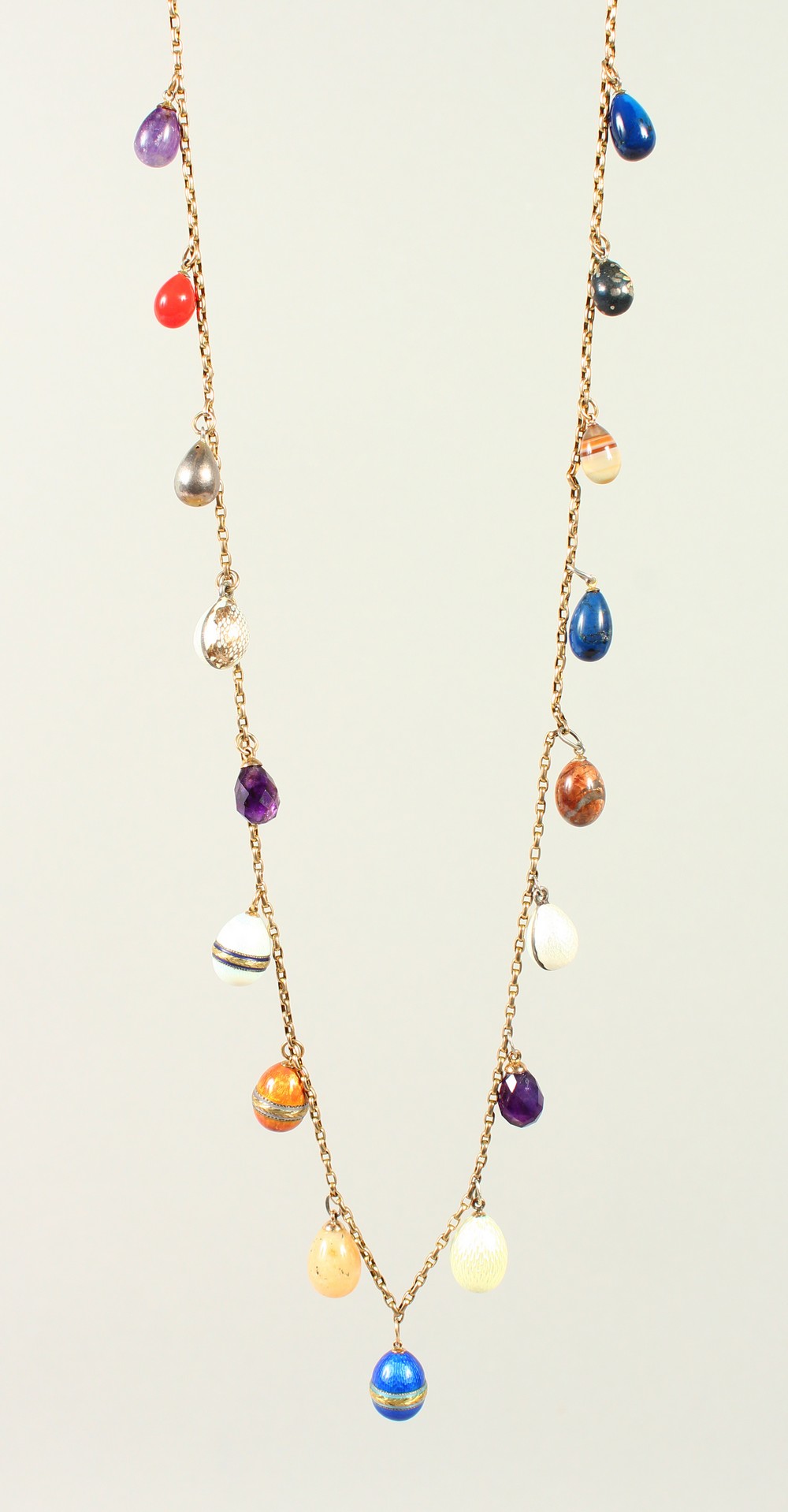 A CHAIN set with HARDSTONE EGGS.