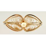 A GOLD AND PEARL FILIGREE BROOCH.