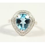 A 14K WHITE GOLD AND DIAMOND RING, set with a pear cut blue topaz approx. 4.42ct, diamonds approx.