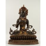 A LARGE BRONZE EASTERN DEITY, inlaid with various hardstones. 45cms high.