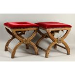 IN THE MANNER OF AWN PUGIN, A PAIR OF UPHOLSTERED STOOLS, overstuffed seats, "X" shaped